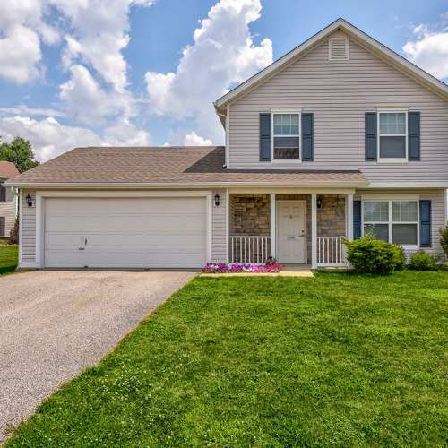 Two-story house with garage and flower bed at Orchard Glen in Orrville, Ohio