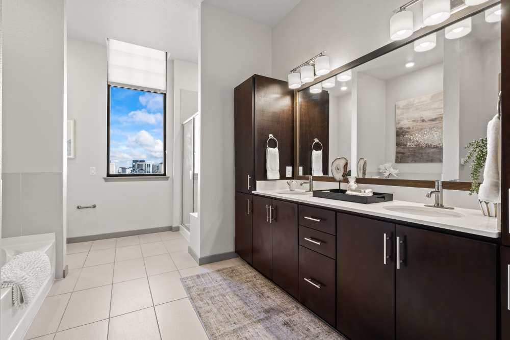 Modern bathroom with large mirror and vanity at Kent Place Residences in Englewood,Colorado