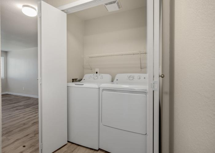 Spacious living room with large couch and carpet flooring at Briarstone in Tacoma, Washington