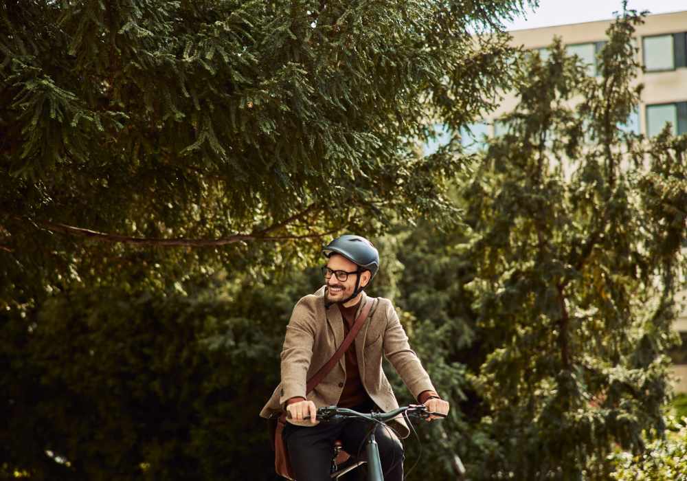 Resident biking on a tree-lined path near North Road Townhomes in Scottsville, New York