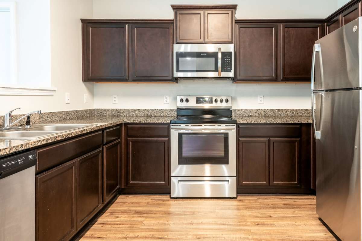 Model Kitchen with stainless appliances at Latitude at Richmond Hill in Richmond Hill, Georgia