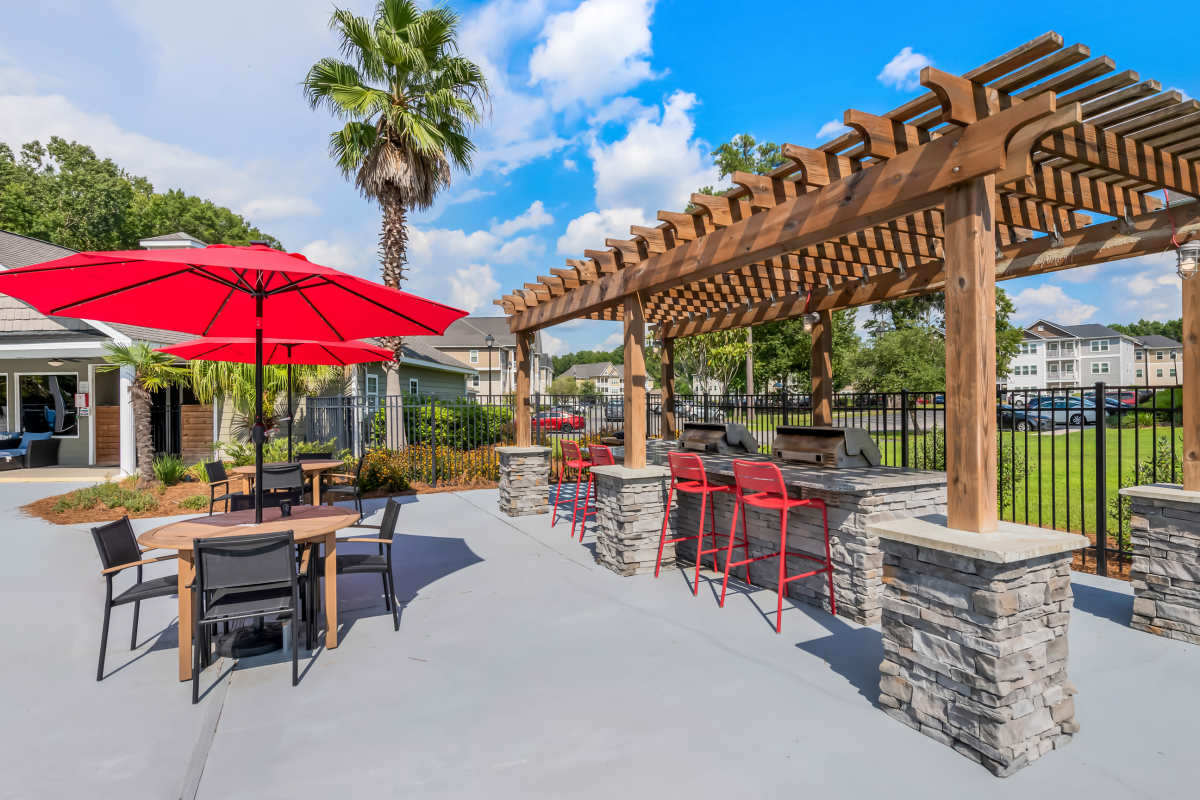 Grilling area and pool deck at Latitude at Richmond Hill in Richmond Hill, Georgia