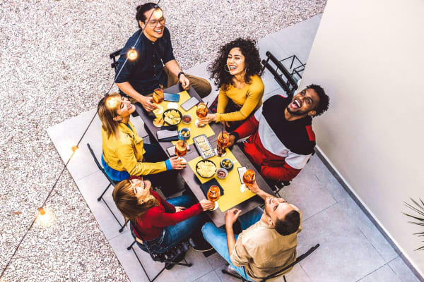 Group of friends eating at a restaurant near Canyon Grove in Grand Prairie, Texas