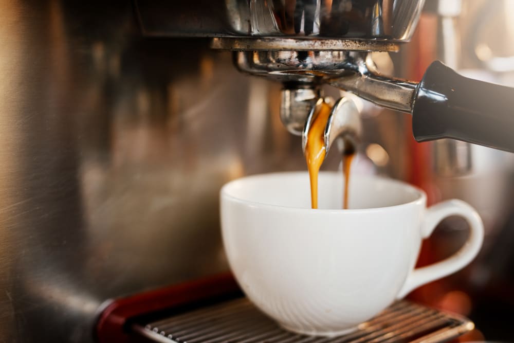 A coffee cup filling with espresso at Applewood Pointe of Champlin at Mississippi Crossings in Champlin, Minnesota. 