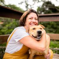 Resident enjoying time with a pet at River Club in Holland, Michigan