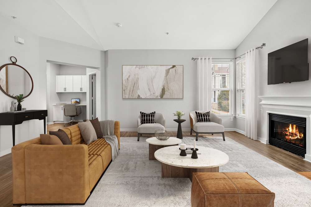 Bright and airy upgraded living room with cozy fireplace. Elegantly furnished at Briargate on Main in Parker, Colorado
