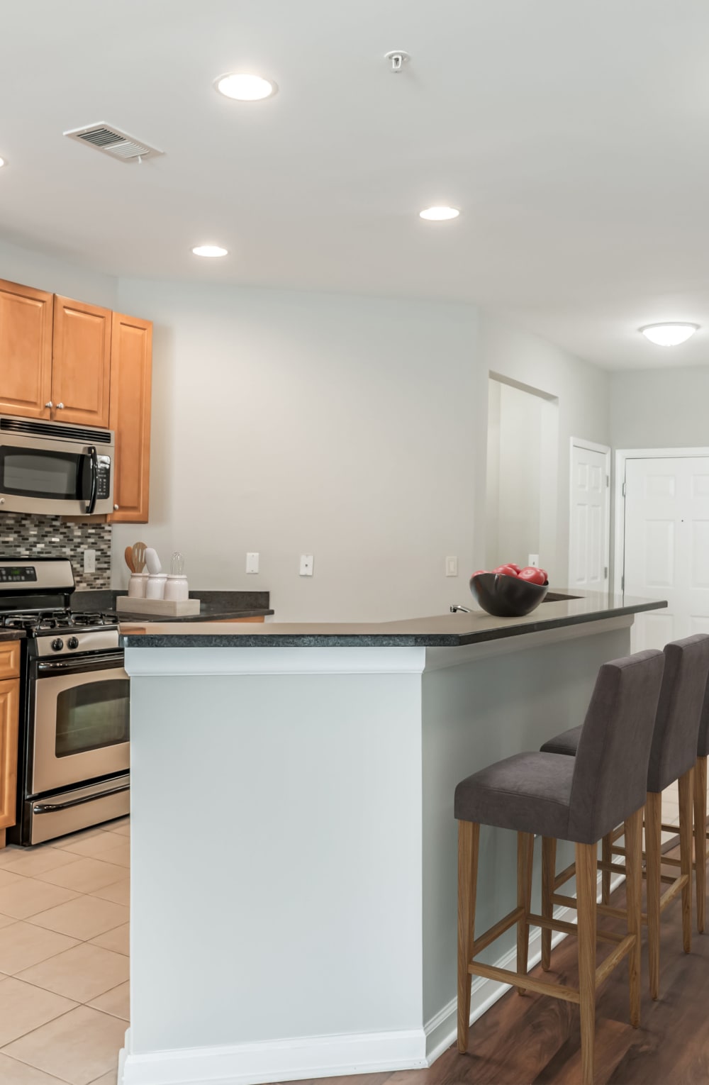 Kitchen with island seating at Cranford Crossing Apartment Homes in Cranford, New Jersey