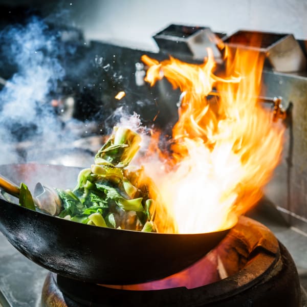 Flaming wok with delicious food near The District at Windy Hill in Atlanta, Georgia
