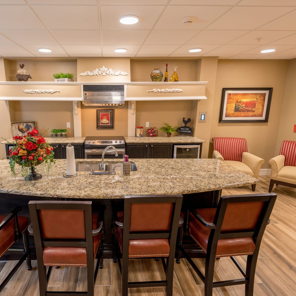Self-service bistro with island seating at Inspired Living Royal Palm Beach in Royal Palm Beach, Florida