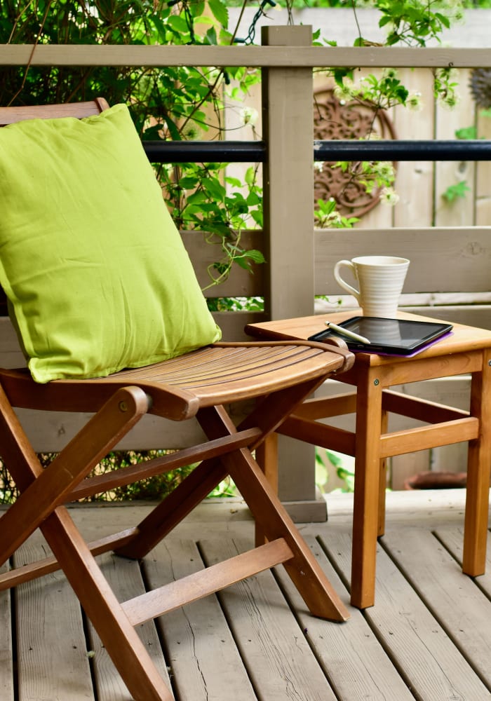 An outdoor chair and table on a patio at Arbor Gates in Fairhope, Alabama