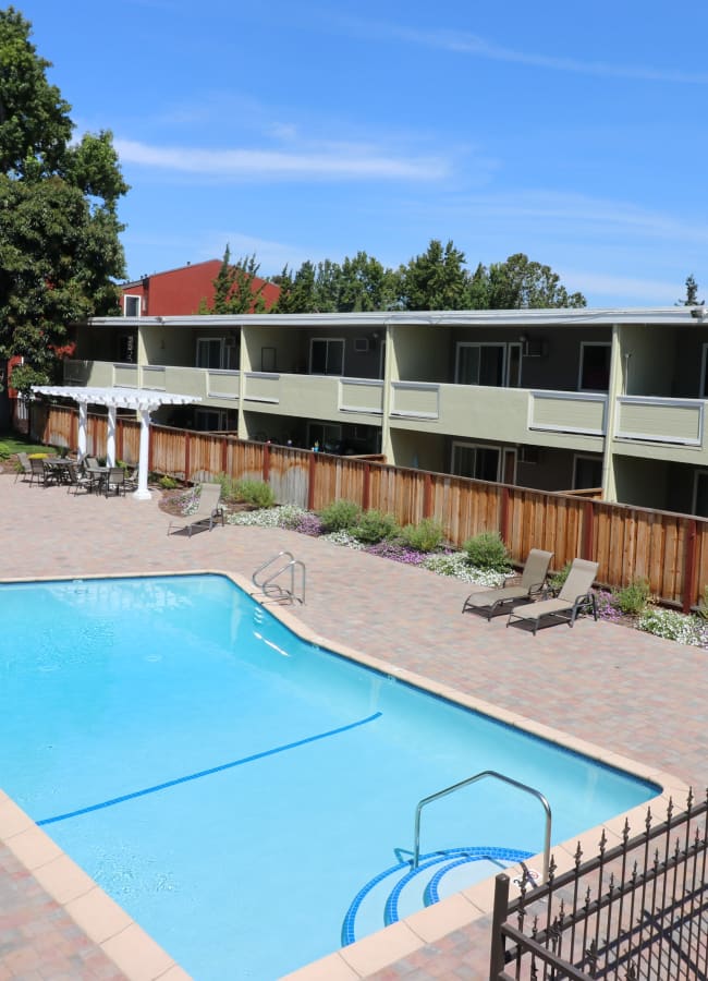 Pool and lounge chairs at Coronado Apartment Homes in Fremont, California