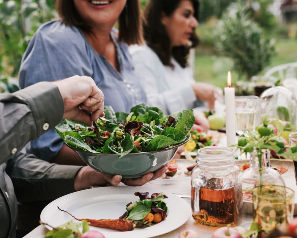 Residents enjoying a salad near Allina La Jolla in San Diego, California