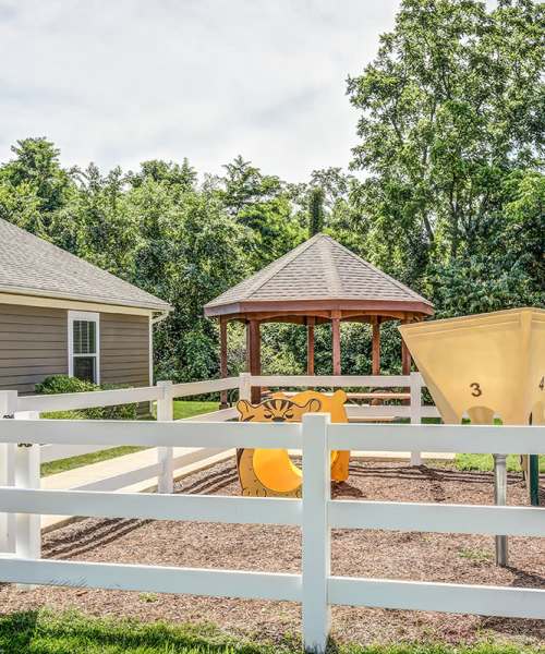 Playground structure with gazebo and fence at Autumn Run in Millersburg, Ohio