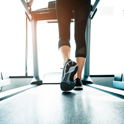 Resident walking on a treadmill at Parkside Towns in Richardson, Texas