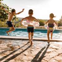 Kids jumping into a pool at Walden Creek in Greenville, South Carolina