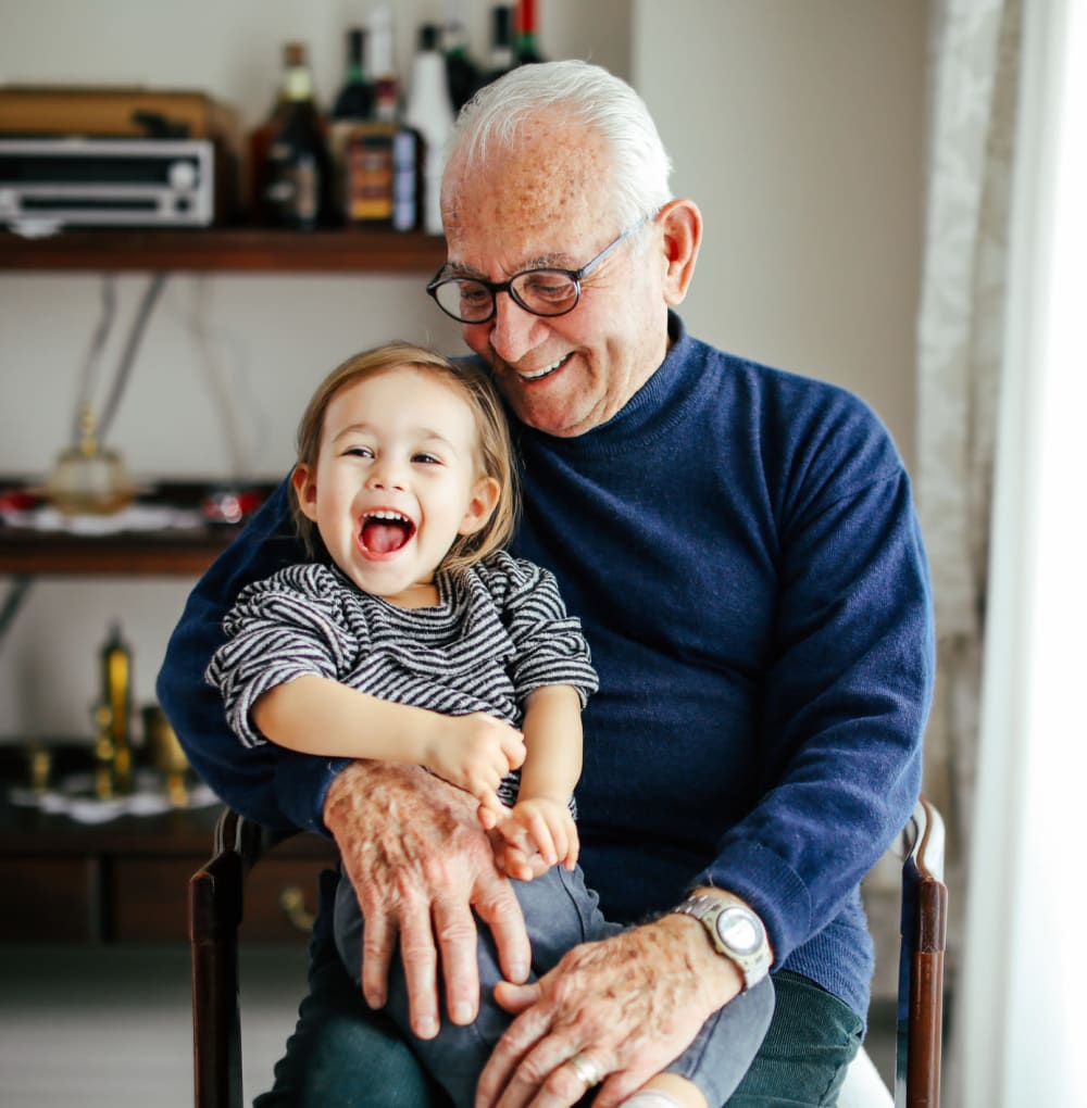 Resident sitting with his grandson in his apartment at Blossom Ridge in Oakland Charter Township, Michigan