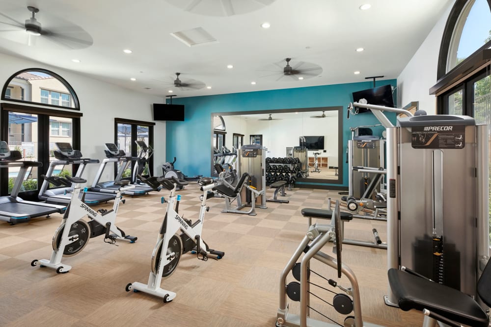 Big workout room full of modern equipment at The Trails at Canyon Crest apartment homes in Riverside, California