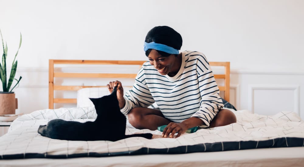 Resident and her cat in a pet-friendly apartment at The Cooper in Fort Worth, Texas