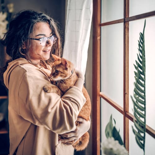 A resident holding her cat at Seaside Village in Oceanside, California