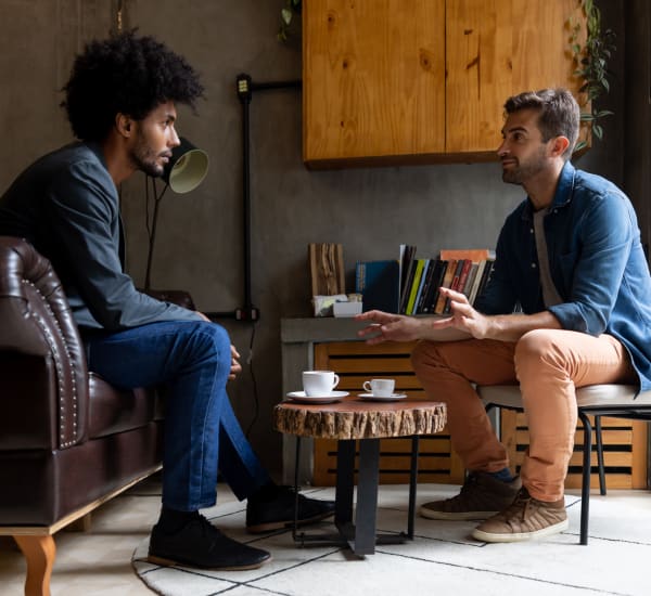 Two men sitting and having a conversation in a coffee shop near Cypress McKinney Falls in Austin, Texas