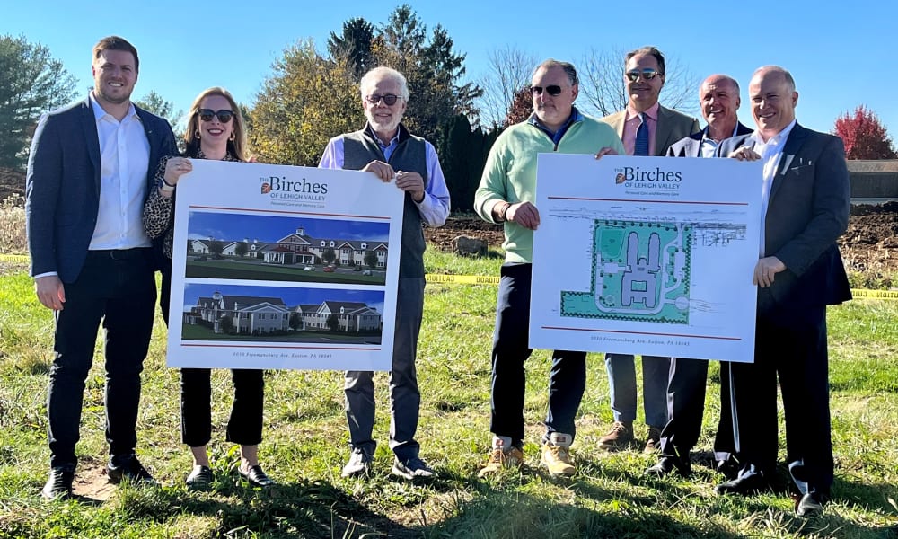 The Birches of Lehigh Valley team holding the renderings of new community in Easton, Pennsylvania