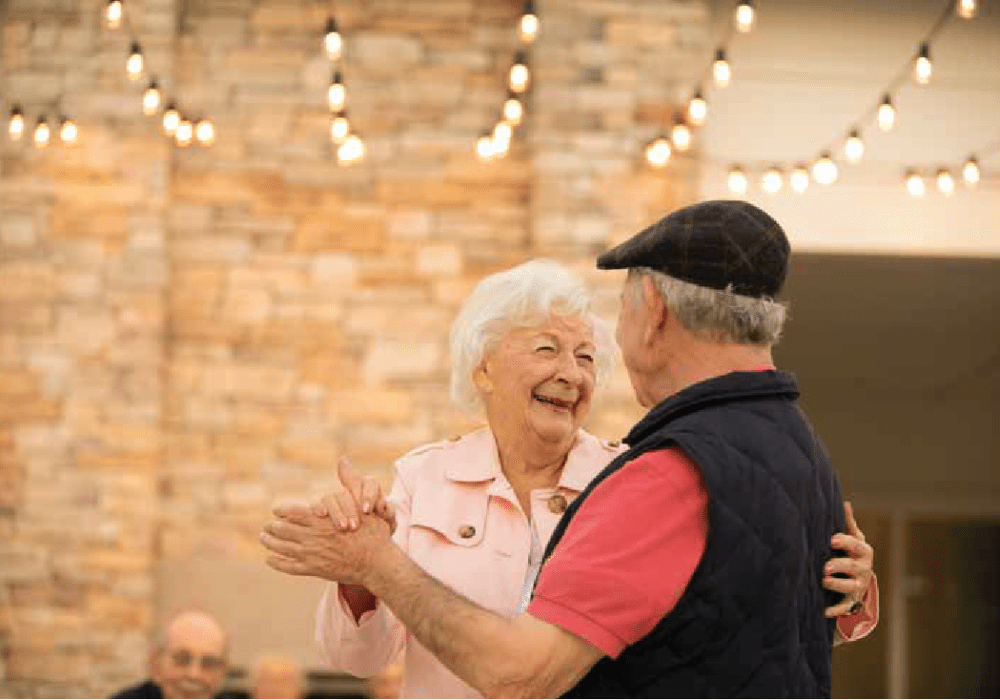 Two residents dancing at Clearwater at The Arboretum in Austin, Texas
