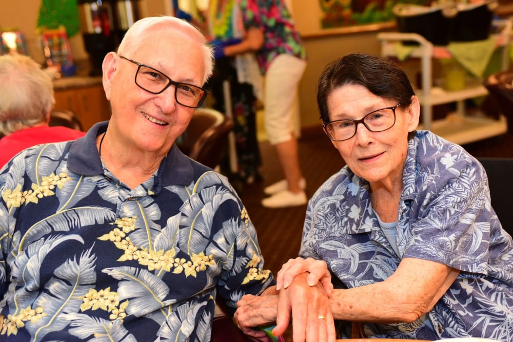 Happy couple eating dinner together in the dining room at River Commons Senior Living in Redding, California