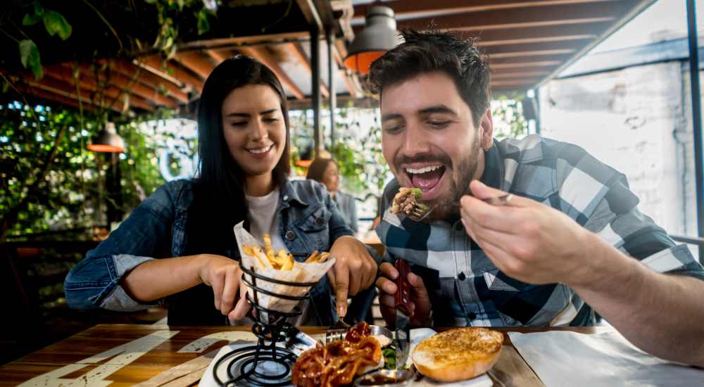 Residents having delicious food at a restaurant near Newland Garden Apartments in Garden Grove, California 