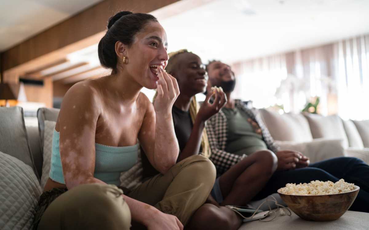 Residents having popcorn while watching a movie at Addison Grove in Avon Park, Florida