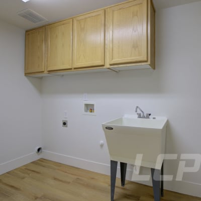 Storage cabinets in laundry area in a home at Beachwood South in Joint Base Lewis McChord, Washington