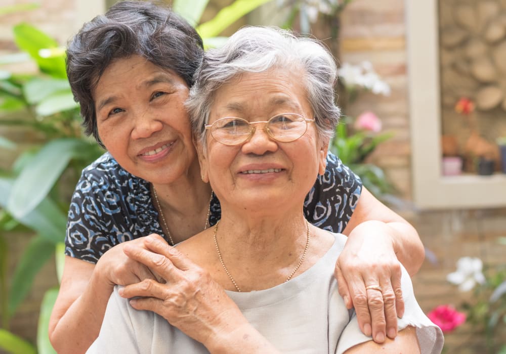 Resident friends hugging at Belmare Senior Living in Oakdale, California. 
