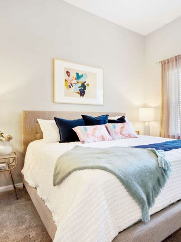 Model bedroom with plush carpeting at Woodside Eleven in Greenville, South Carolina