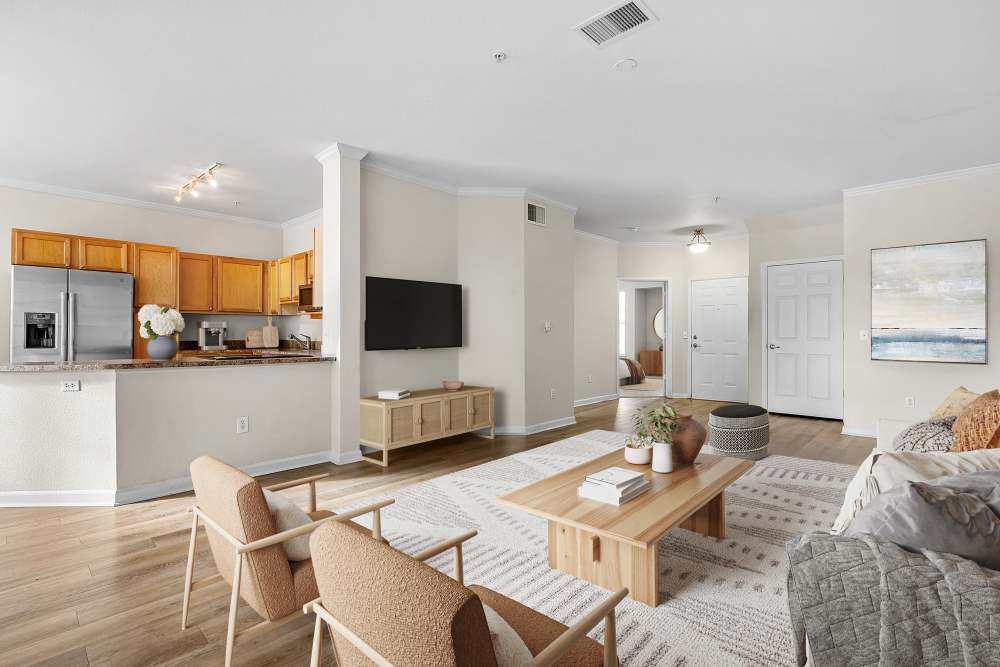 Furnished living room and open kitchen with huge breakfast bar at Briargate on Main in Parker, Colorado