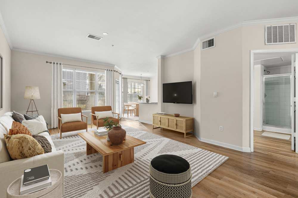 Bright and airy furnished living room with hardwood style flooring at Briargate on Main in Parker, Colorado