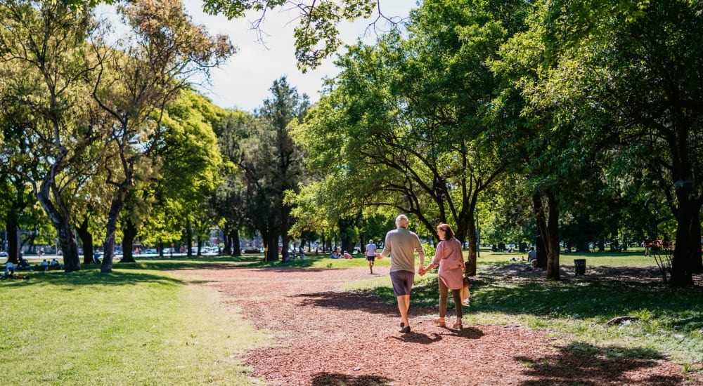 Couple walking through a park near their home at The Springs in La Mesa, California
