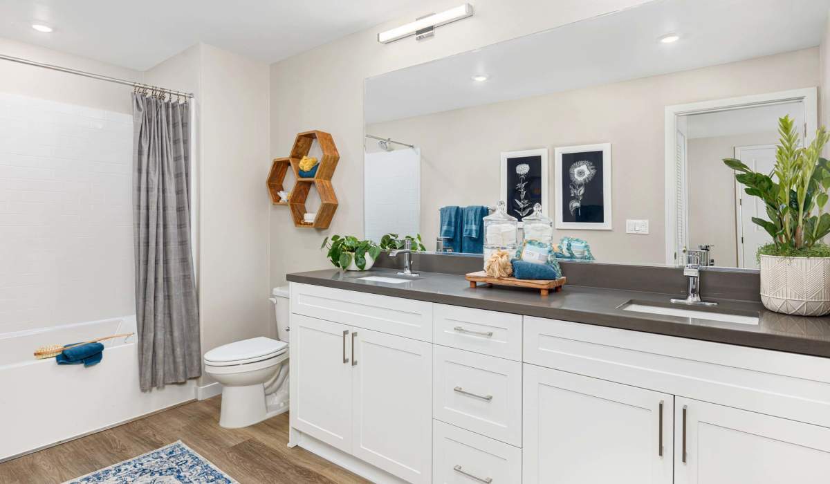 Spacious White Bathroom with sink and gray granite countertop at Atwell at Folsom Ranch in Folsom, California