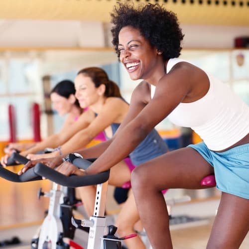 Riding a stationary bike in the fitness center at Avisa Lakes in Orlando, Florida