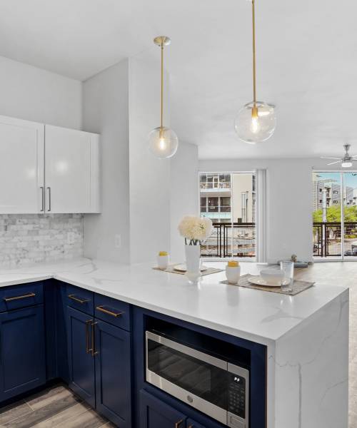 Kitchen with white cabinetry at The Lofts At West 7th in Fort Worth,Texas