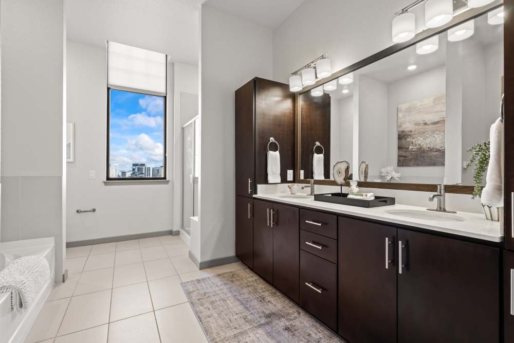 Dual vanity bathroom with huge walk in closet at Kent Place Residences in Englewood, Colorado