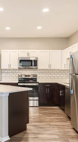 Kitchen with island and backsplash at Panorama at Arvada Ridge in Arvada,Colorado