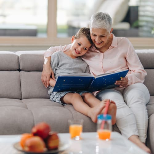 A resident with kid reading a story at Prospect View in Santee, California