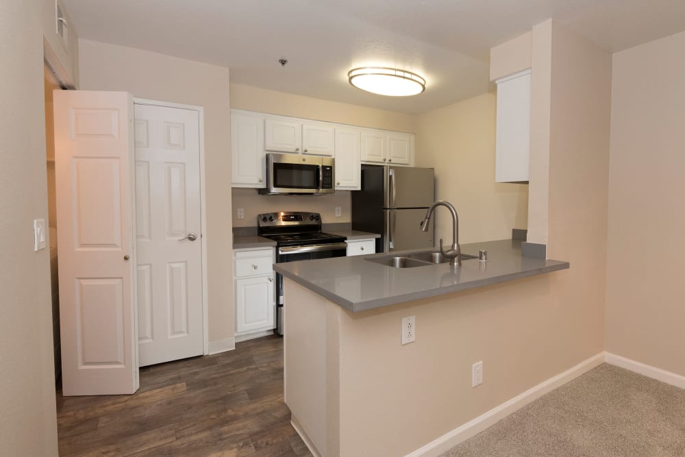 Apartment kitchen with stainless-steel appliances at Sterling Heights Apartment Homes in Benicia, California