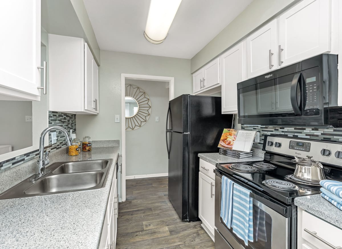 Spacious kitchen with a microwave in model apartment home of Barringer Square in Webster, Texas