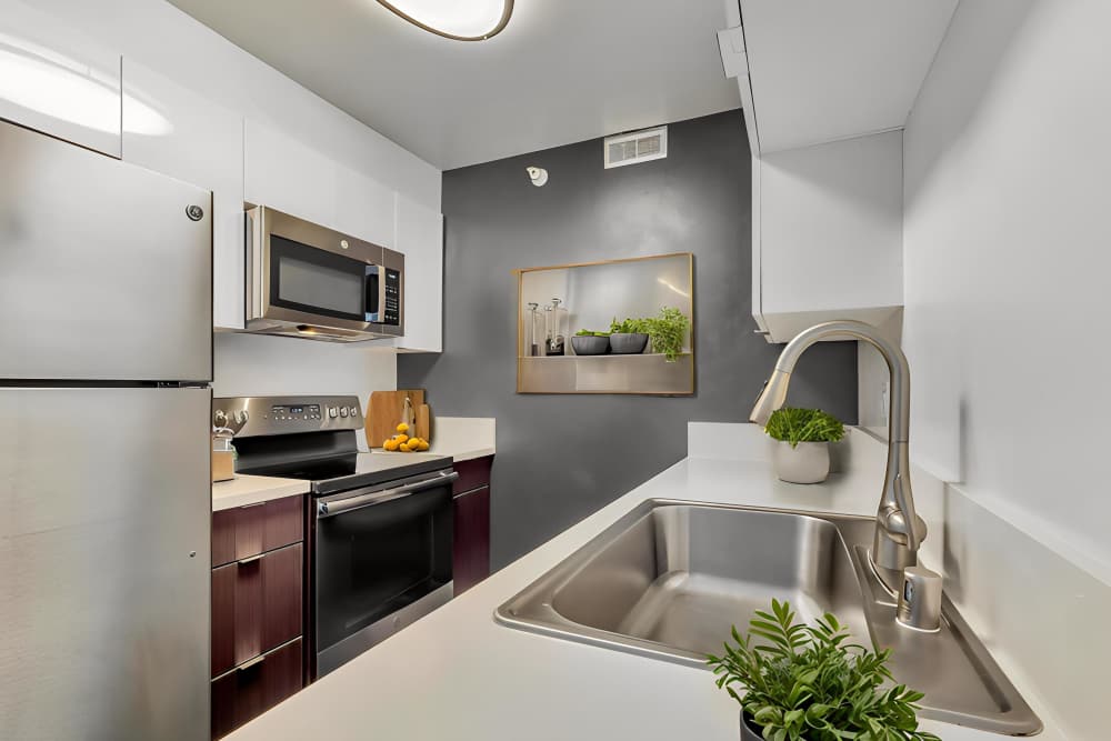 Apartment kitchen with stainless steel finishes at Promenade Towers in Los Angeles, California