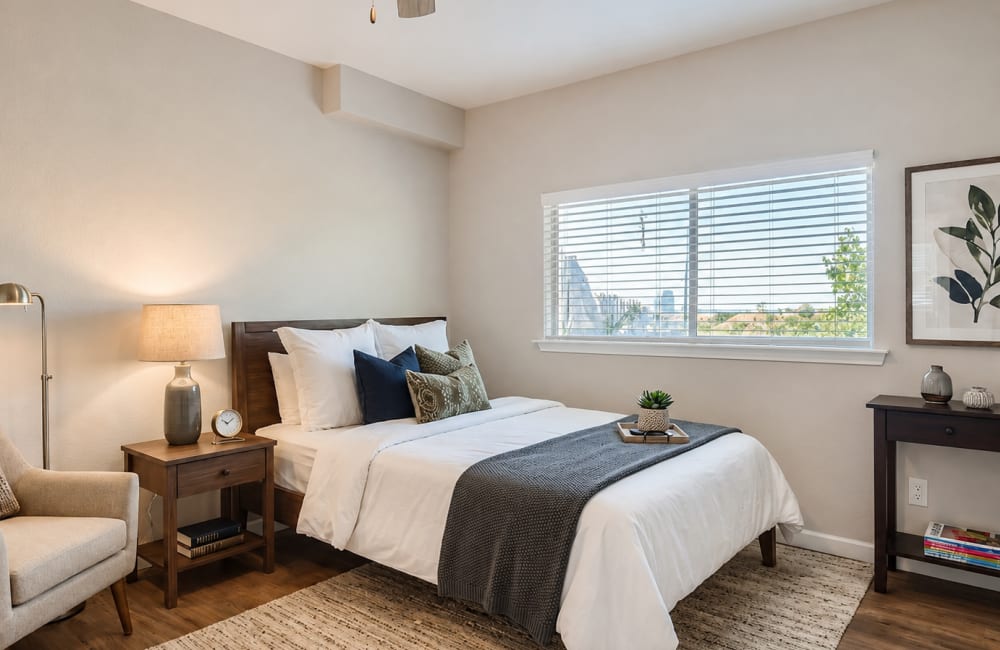 Bedroom with carpet flooring, side lamp, chair and window at Ascent at Lake Worth in Fort Worth, Texas
