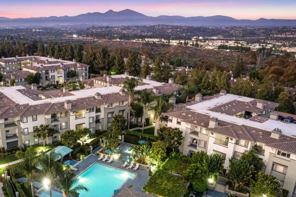 Beautiful swimming pool at dusk at Alicante Apartment Homes in Aliso Viejo, California