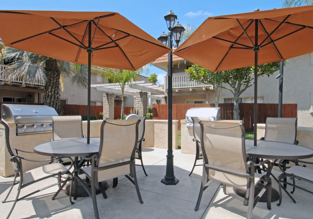 Outdoor tables with umbrellas to stay cool in the sun at Terra Camarillo in Camarillo, California
