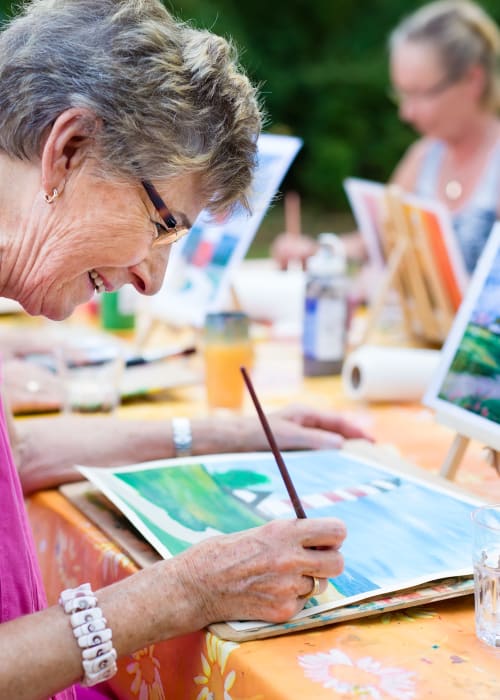 Group of residents outdoors painting at Burton Health Care Center in Burton, Ohio