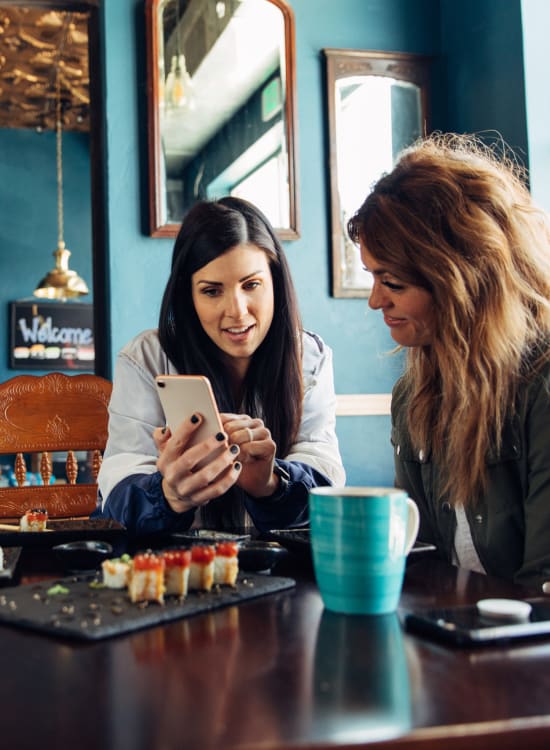 Women relaxing at a coffee shop nearby at Solaire 7077 Woodmont in Bethesda, Maryland