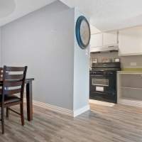 View of kitchen from dining area at Woodland Village Apartments in Breckenridge, Texas